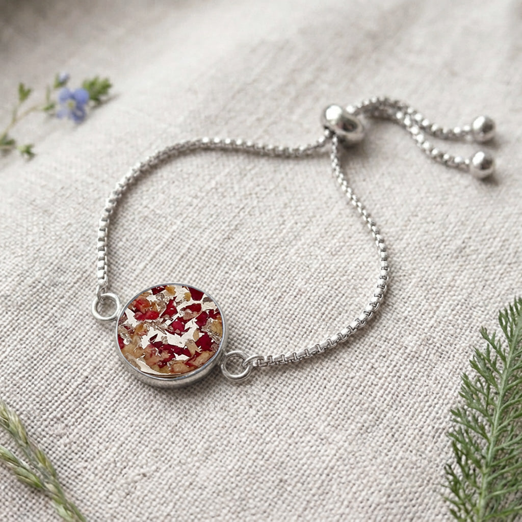 Handcrafted stainless steel bracelet featuring real rose petals preserved in clear resin on fine linen. Made in Finland by byMinta.