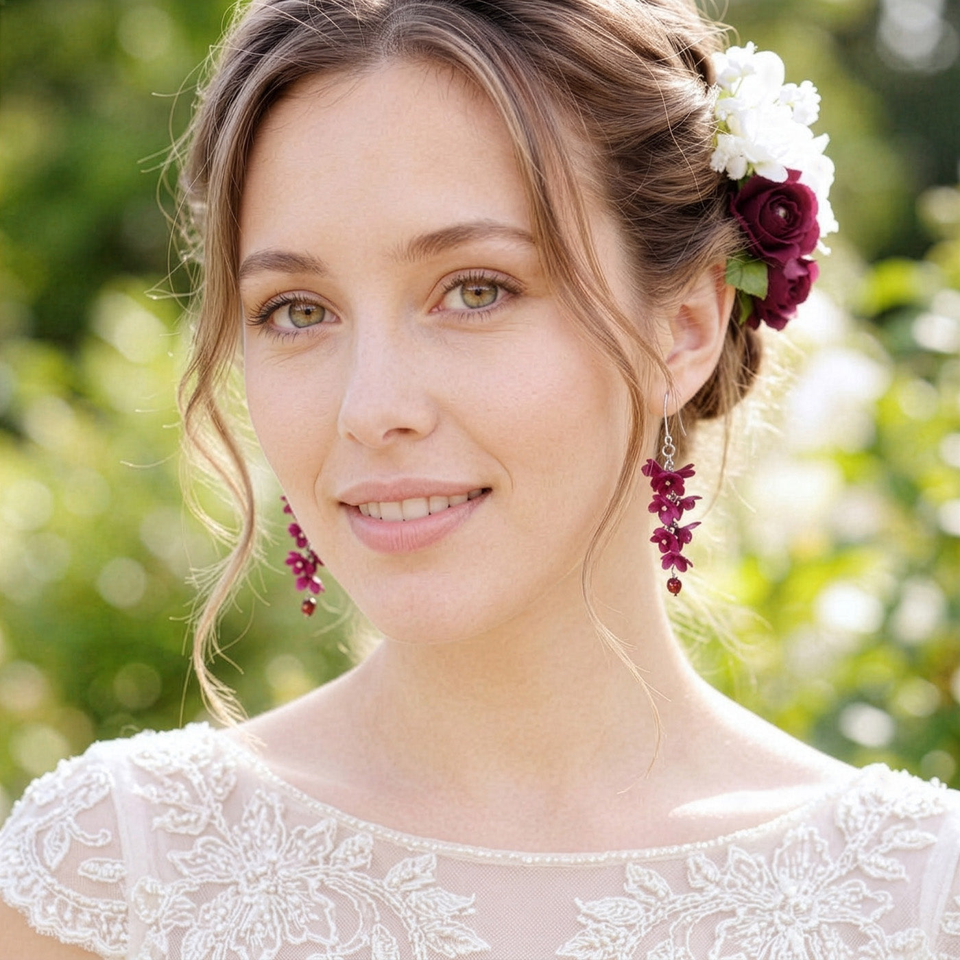 Woman wearing Shadow Vine Burgundy Earrings in a soft summer garden. Handmade floral earrings inspired by the rich and elegant tones of burgundy.
