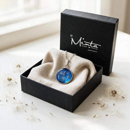 Black jewelry box with a handmade dandelion seed necklace featuring real dandelion seeds preserved in resin