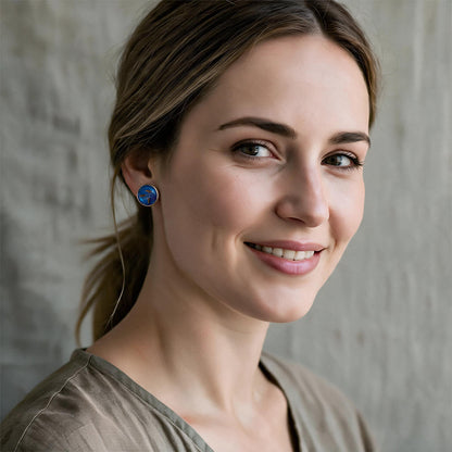 Woman wearing handmade dandelion seed stud earrings with real dandelion seeds preserved in resin, handcrafted in Finland.