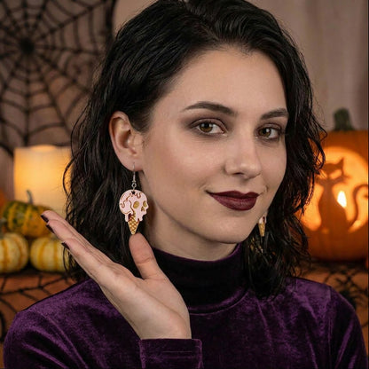 Halloween ice cream earrings worn by a model, lightweight handmade Halloween earrings.