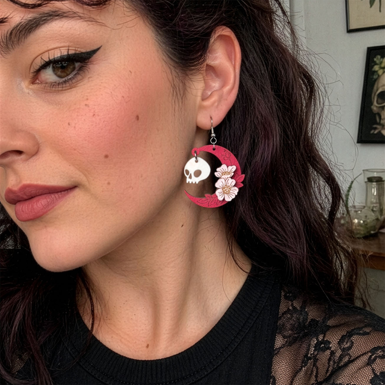 Handmade pink crescent moon skull earring Finland byMinta, worn on ear, lightweight wooden Halloween jewelry, model try-on