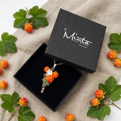 Cloudberry Bog Necklace presented in a gift box, surrounded by natural linen fabric, fresh cloudberries, and green cloudberry leaves in soft natural light. Handmade necklace with hand-shaped berries and leaves, handmade in Finland by byMinta.