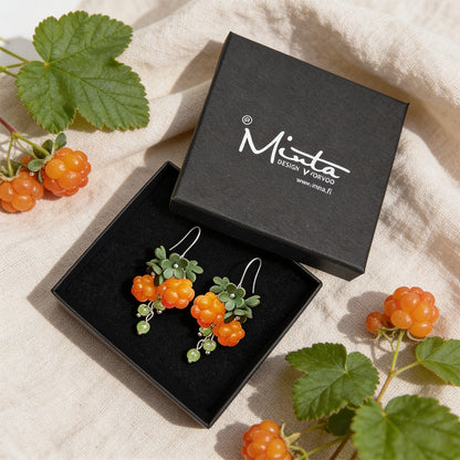 Cloudberry Sprout Earrings presented in a gift box, surrounded by natural linen fabric, fresh cloudberries, and cloudberry leaves. Handmade in Finland by byMinta.
