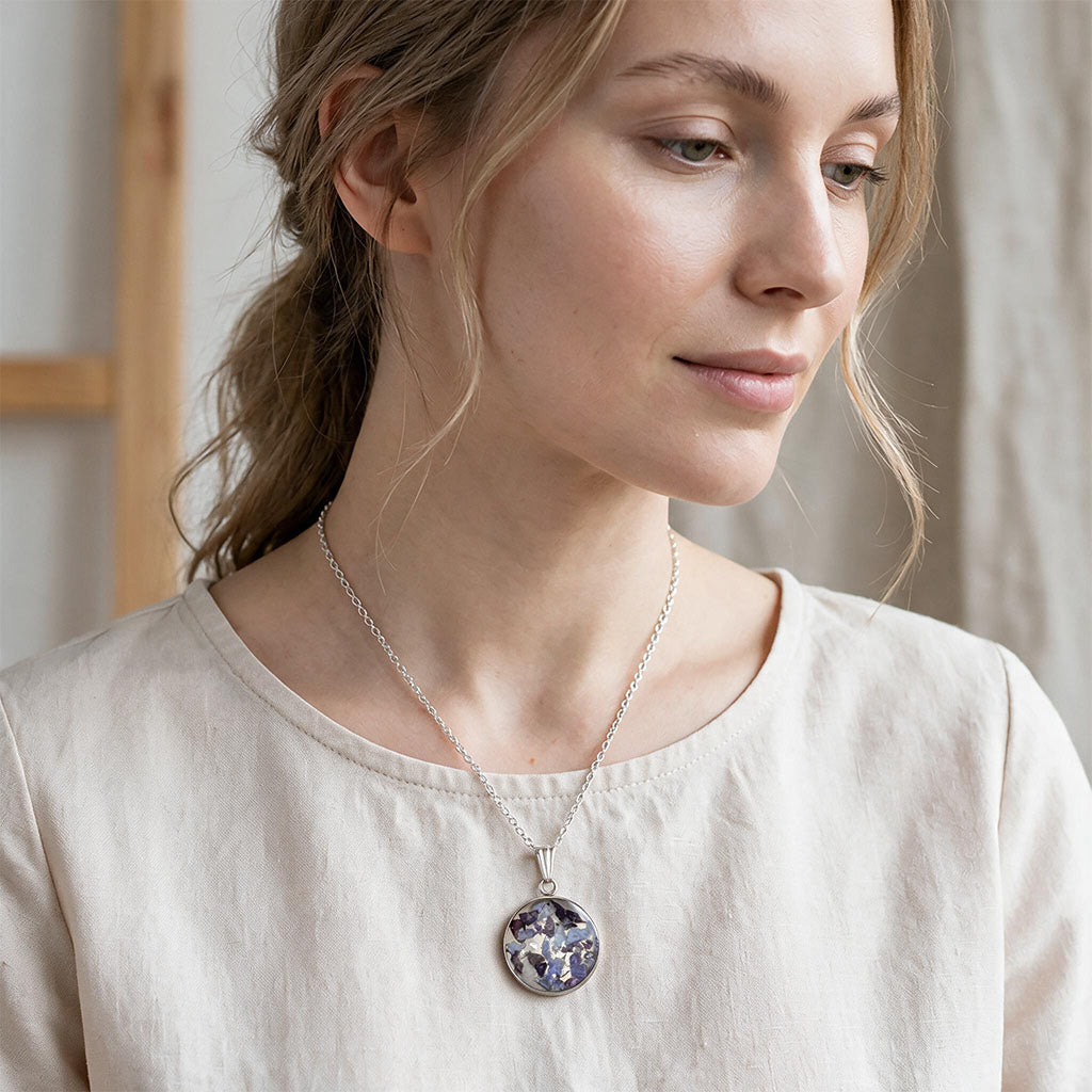 Woman wearing a handmade hydrangea necklace with real hydrangea flowers preserved in resin