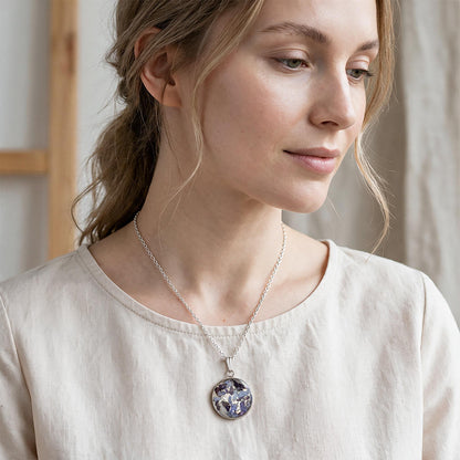 Woman wearing a handmade hydrangea necklace with real hydrangea flowers preserved in resin
