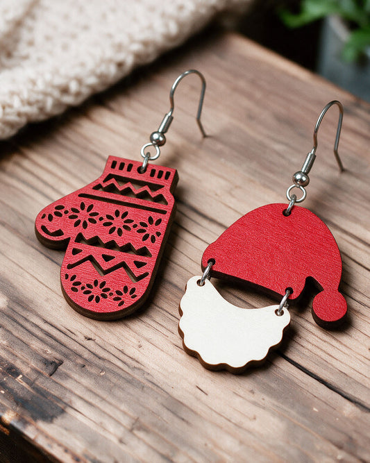Santa Claus mitten earrings made in Finland, photographed on a wooden table in natural light