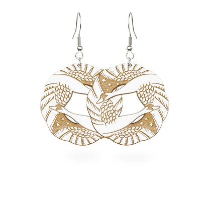 Laser-cut wooden swan earrings by byMinta with detailed feather engraving, handmade in Finland.