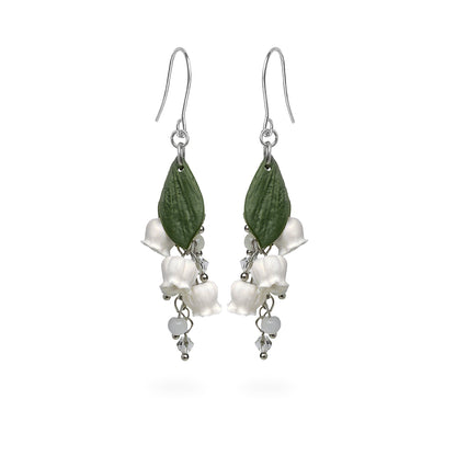 Lily of the Valley Earrings featuring delicate white bell-shaped flowers, green leaves, and crystal details. Handmade in Finland by byMinta.
