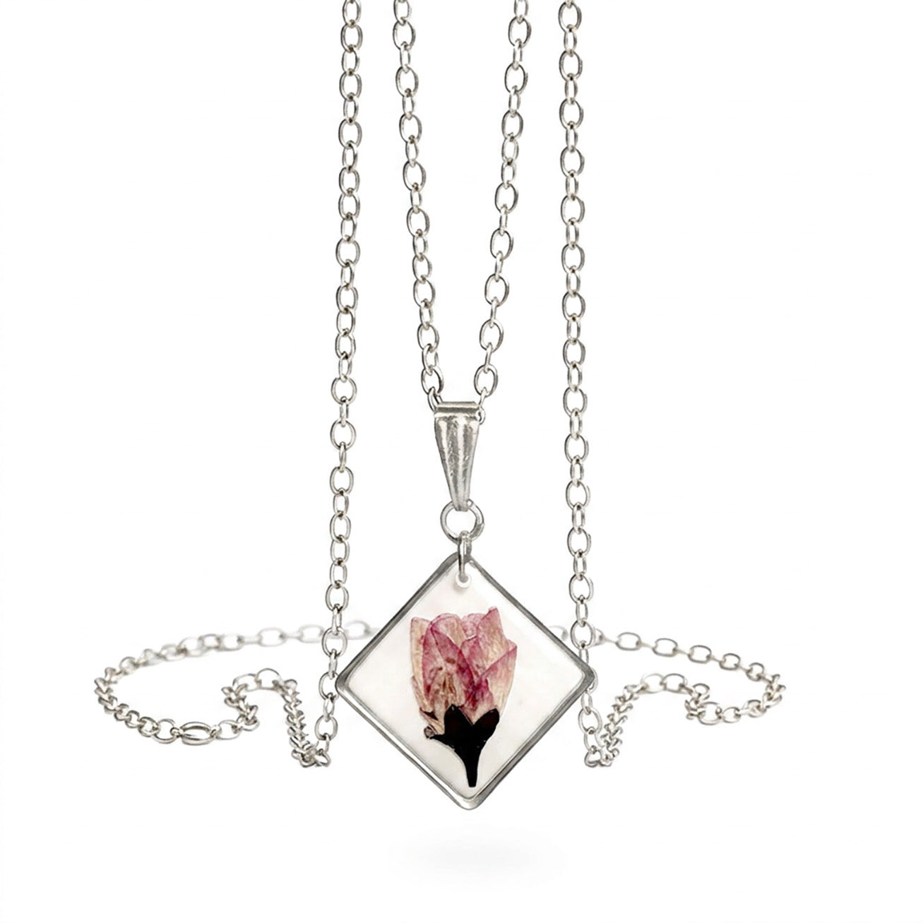Minimalist cherry blossom necklace with real flower pendant and stainless steel chain on white background