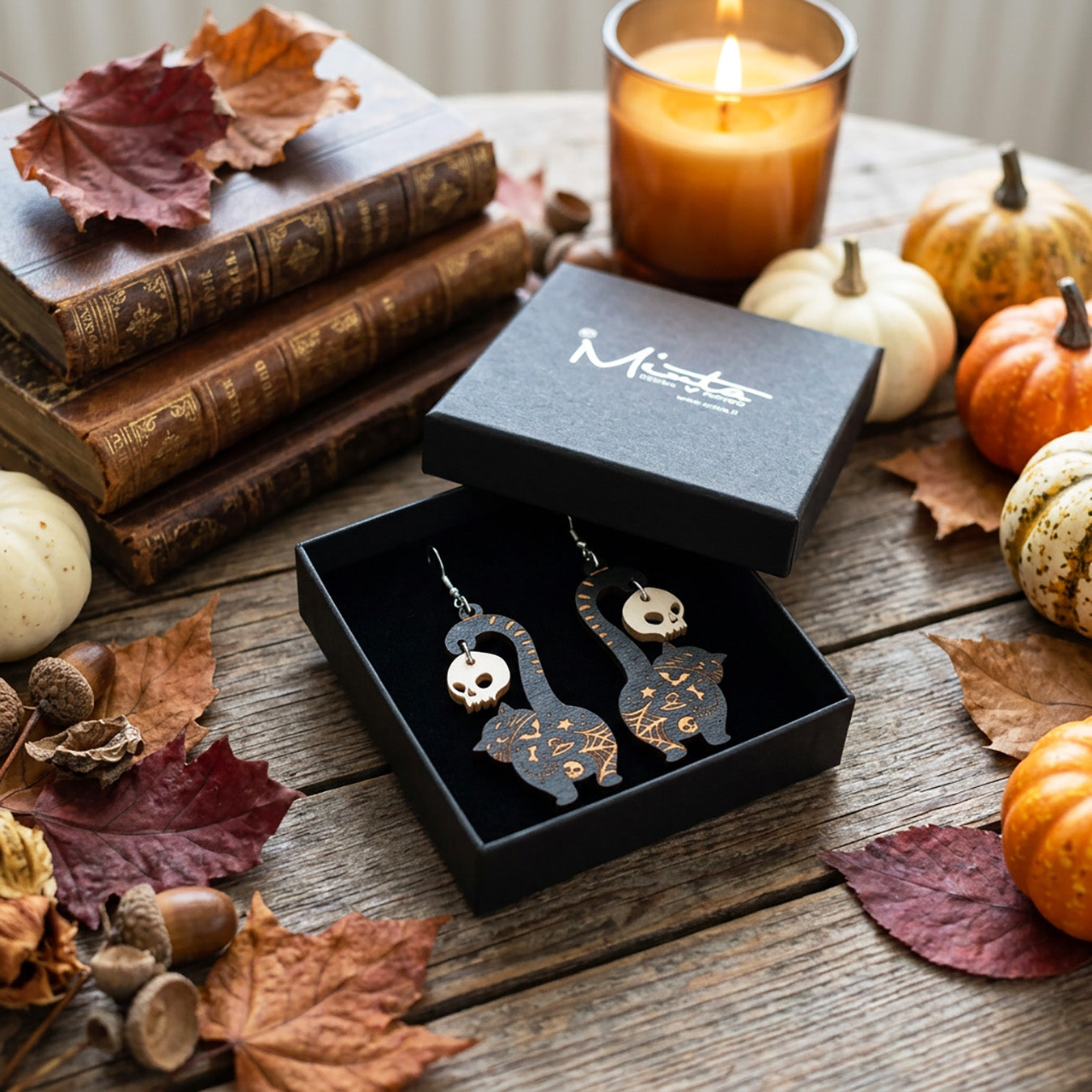 Black cat earrings with skull charms in byMinta gift box, handmade Halloween earrings from Finnish birch plywood.