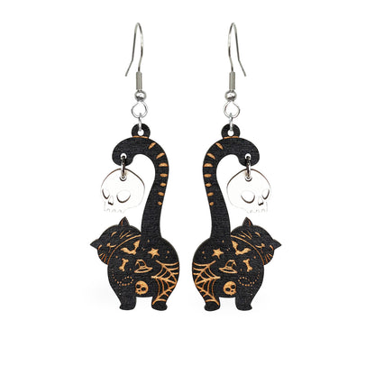 Black cat earrings with skull charms, handmade Halloween earrings from Finnish birch plywood, white background.
