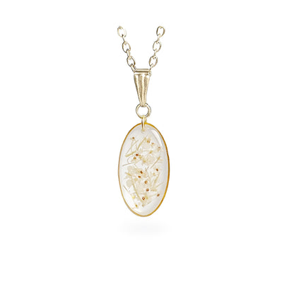 Handmade oval necklace with real pressed cow parsley flowers preserved inside clear resin. Botanical jewelry with a delicate gold-tone frame and chain on a clean white background, handcrafted in Finland.