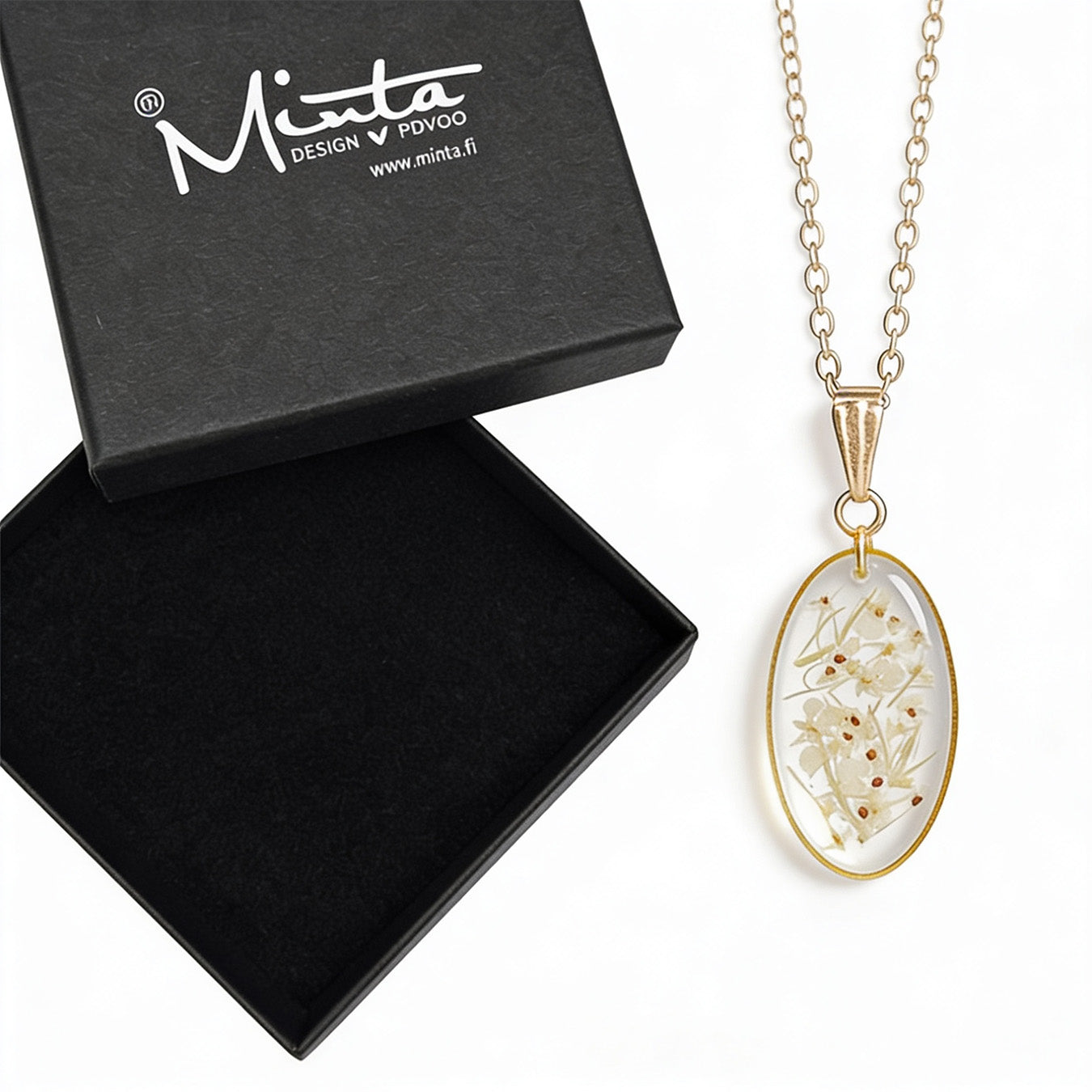 Handmade botanical necklace with real pressed cow parsley flowers preserved in clear resin. Delicate gold-tone pendant and chain displayed next to a black byMinta jewelry box on a clean white background.