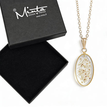 Handmade botanical necklace with real pressed cow parsley flowers preserved in clear resin. Delicate gold-tone pendant and chain displayed next to a black byMinta jewelry box on a clean white background.