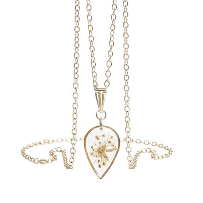 Handmade teardrop necklace with a real pressed cow parsley flower preserved inside. Botanical jewelry with a gold-tone frame and delicate chain on a clean white background, handcrafted in Finland.