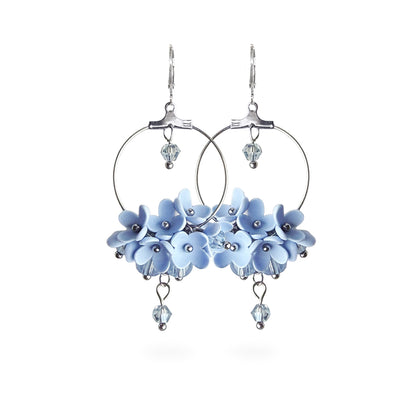 Light Blue Flower Vine Hoop Earrings featuring delicate pale blue flowers, airy silver hoops, and sparkling crystal details. Handmade in Finland by byMinta.