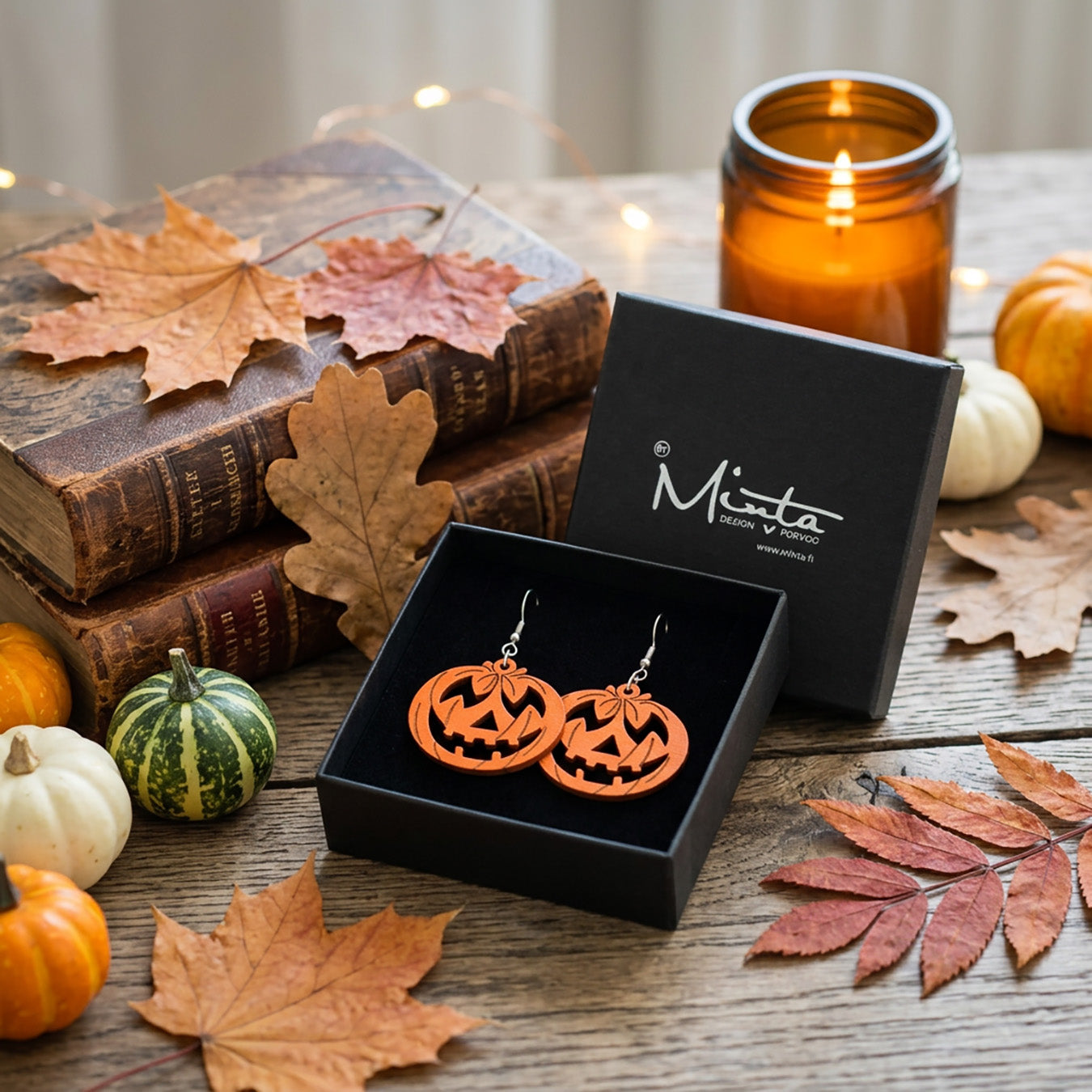 Pumpkin earrings in byMinta gift box with autumn leaves and candles.