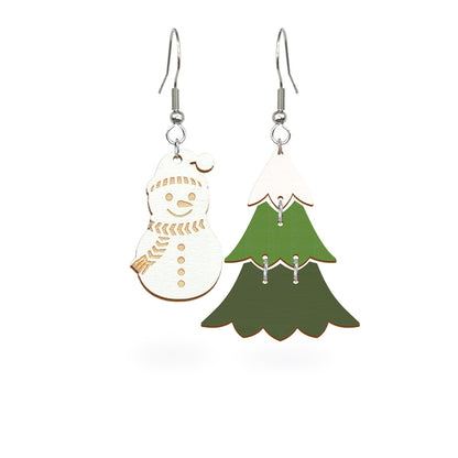 Playful mismatched earrings featuring a snowman and a green Christmas tree, handmade from Finnish birch plywood and painted on both sides. Handmade in Finland by byMinta.