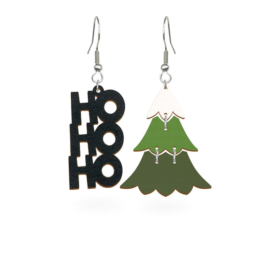 Playful mismatched earrings featuring a black HO HO HO design and a green Christmas tree, handmade from Finnish birch plywood and painted on both sides. Handmade in Finland by byMinta.