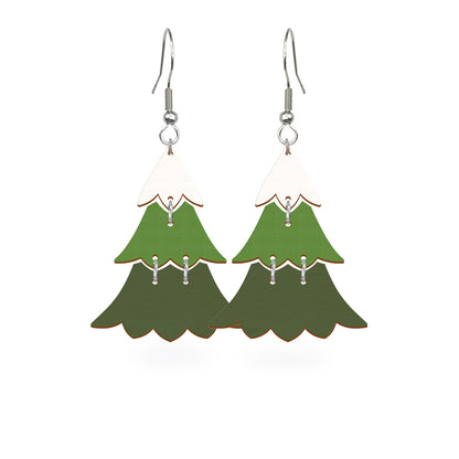 Christmas tree earrings handmade from Finnish birch plywood, painted on both sides and inspired by the peaceful beauty of winter forests. Handmade in Finland by byMinta.