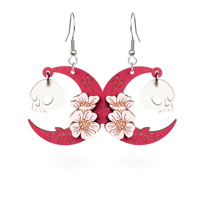 Pink crescent moon earrings with skull charms and flowers, handmade wooden Halloween earrings byMinta Finland