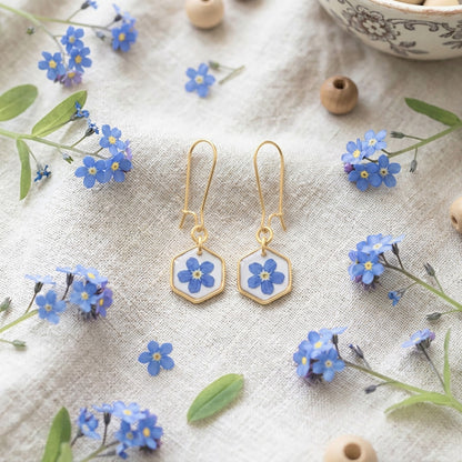 Handmade forget-me-not flower earrings with 18K gold plated hooks styled with blue flowers on linen fabric
