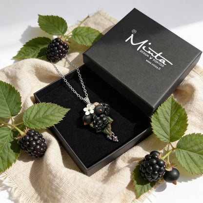 Berry Harvest Necklace presented in a gift box, surrounded by natural linen fabric, fresh blackberries, and green blackberry leaves. Handmade necklace with hand-shaped berries and leaves, photographed in soft natural light. Handmade in Finland by byMinta.