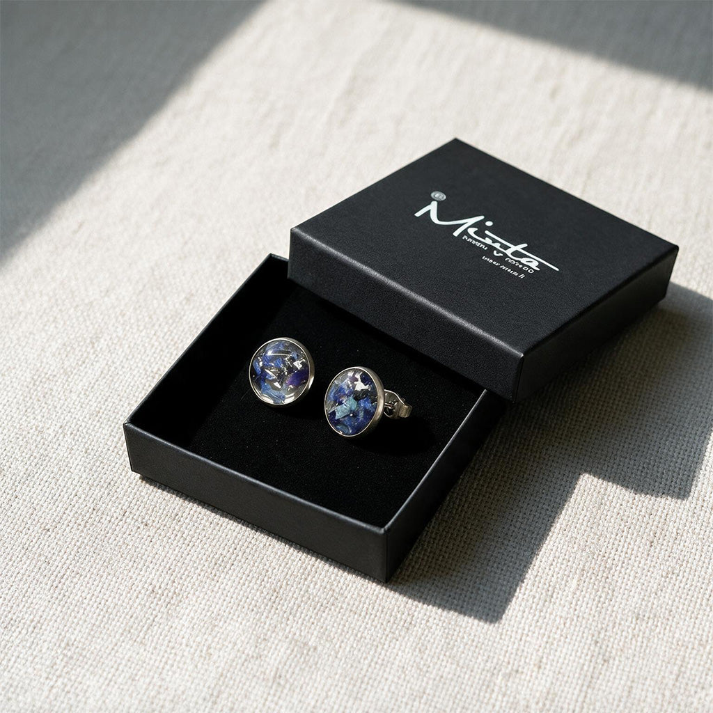 Hydrangea stud earrings displayed in a black byMinta gift box on a linen background, handcrafted in Finland with real hydrangea flowers preserved in resin.