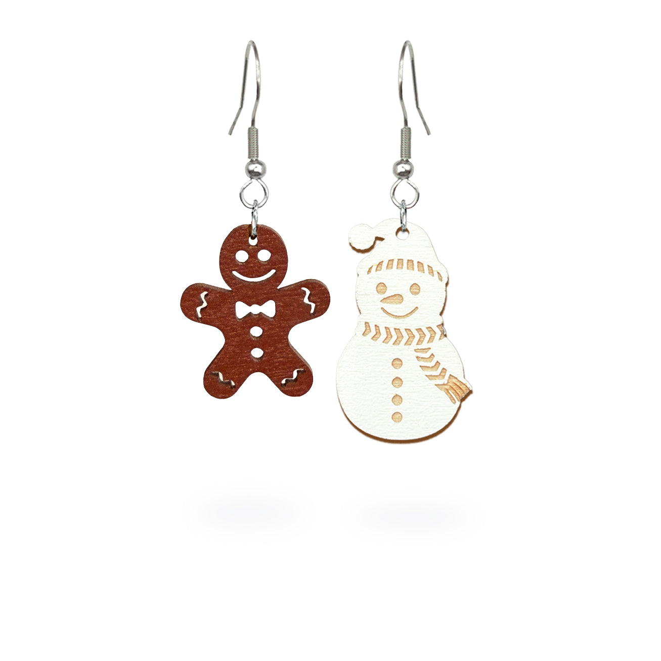 Playful mismatched earrings featuring a gingerbread cookie and a snowman, handmade from Finnish birch plywood and painted on both sides. Handmade in Finland by byMinta.