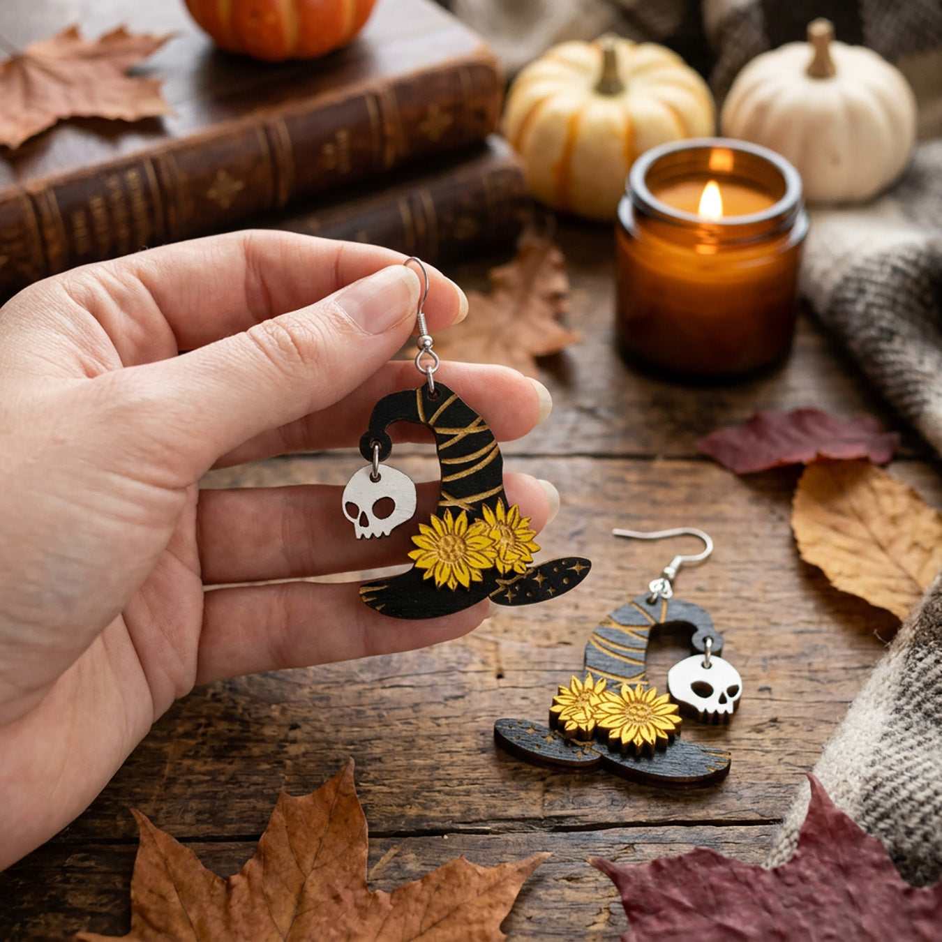 Hand holding lightweight Witch Hat Earrings for size reference.