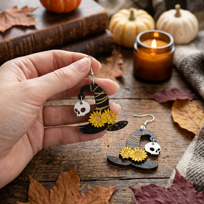 Hand holding lightweight Witch Hat Earrings for size reference.