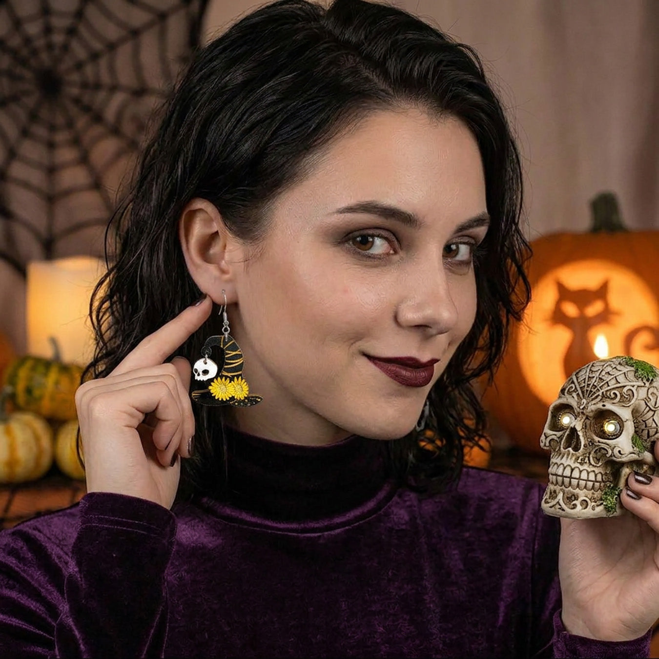 Woman wearing Witch Hat Earrings in a cozy Halloween setting.