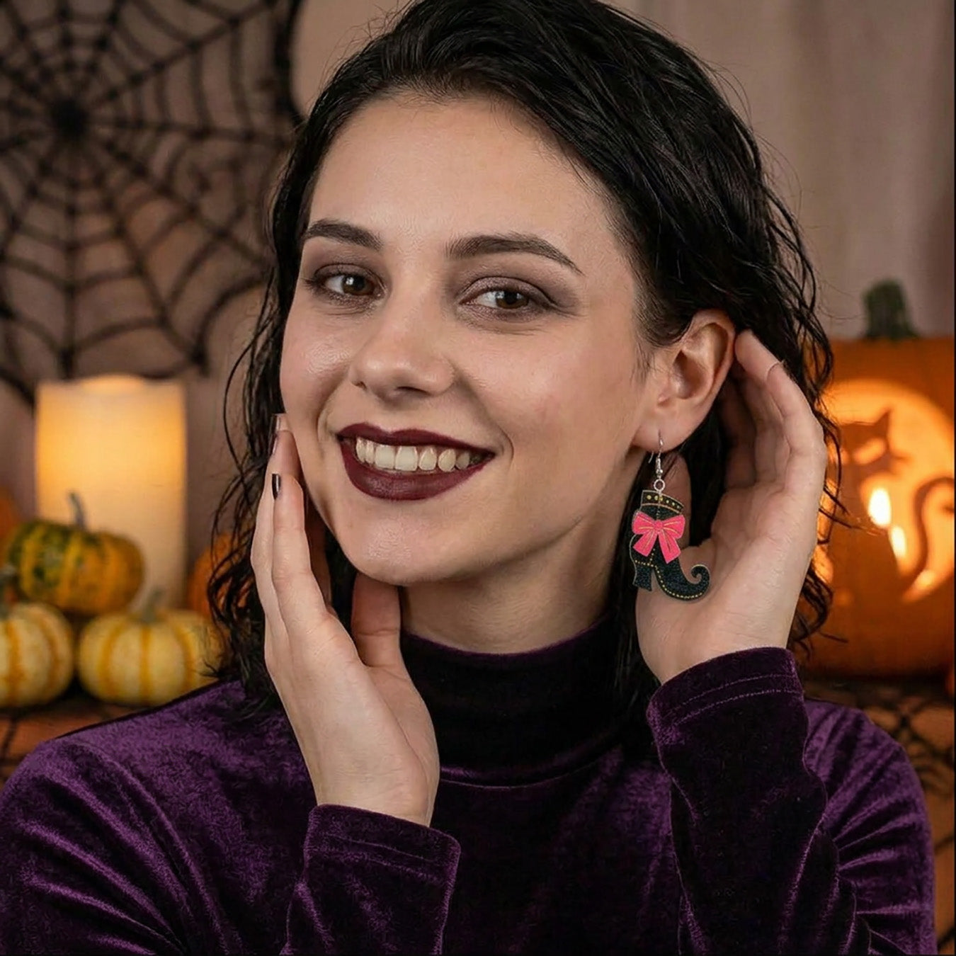 Witch shoes earrings worn by a model, lightweight handmade Halloween earrings.