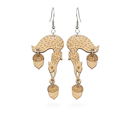 Handmade squirrel earrings crafted from Finnish birch plywood. Lightweight statement earrings featuring squirrels and dangling acorns with engraved details and a Nordic forest-inspired design.