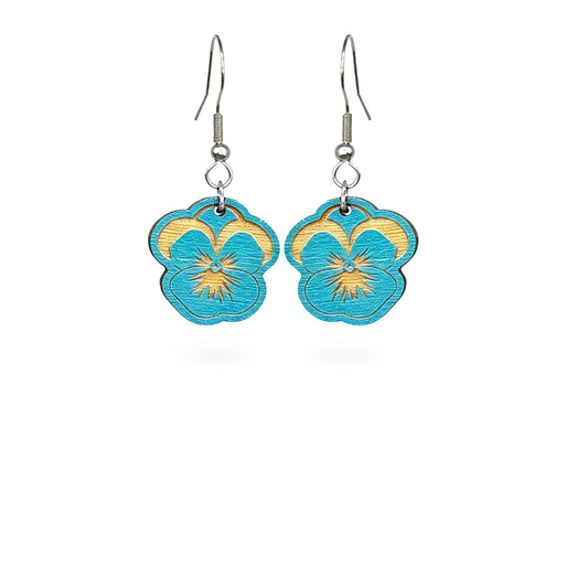 Handmade sky blue pansy earrings crafted from Finnish birch plywood. Lightweight floral earrings with delicate engraved details and fresh Nordic spring-inspired design.