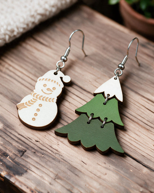 Winter-themed Christmas earrings made in Finland, photographed on a wooden table in natural light