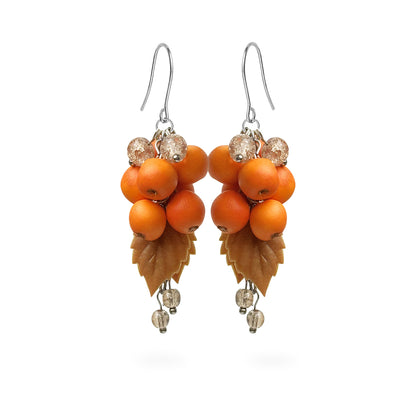 Rowan Berry Earrings featuring hand-shaped orange rowan berries, autumn leaves, and sparkling crystal details. Handmade in Finland by byMinta.