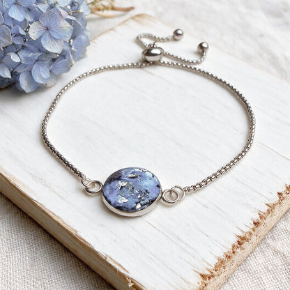 Handcrafted stainless steel bracelet featuring real hydrangea petals preserved in clear resin on fine linen. Made in Finland by byMinta.
