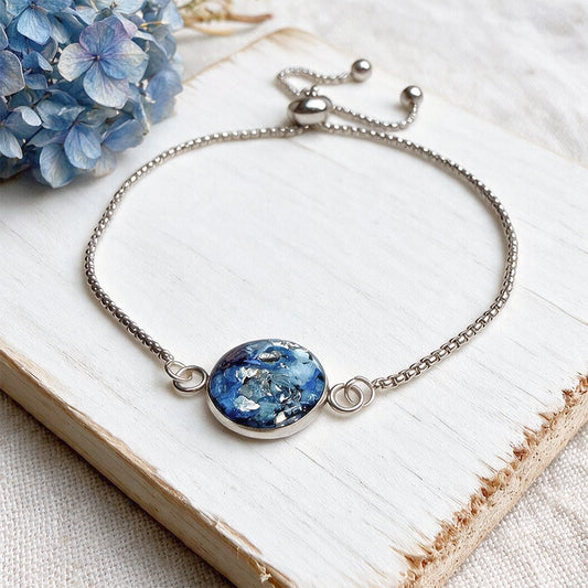 Handcrafted stainless steel bracelet featuring real hydrangea petals preserved in clear resin on fine linen. Made in Finland by byMinta.
