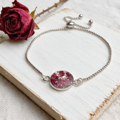 Handcrafted stainless steel bracelet featuring real rose petals preserved in clear resin on fine linen. Made in Finland by byMinta.