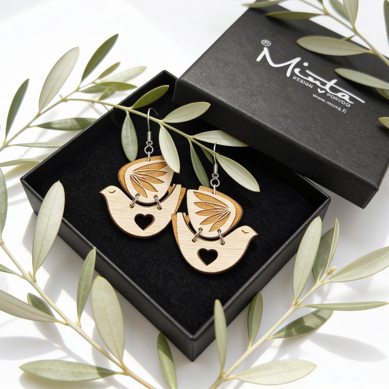 Peace Dove wooden earrings by byMinta displayed with delicate olive branches, symbolizing peace, love and hope.