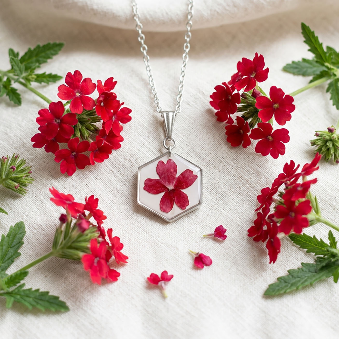 Handmade verbena flower necklace with stainless steel chain surrounded by fresh red verbena flowers