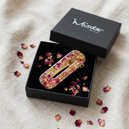 Handmade rose hair clip in gift box with scattered rose petals