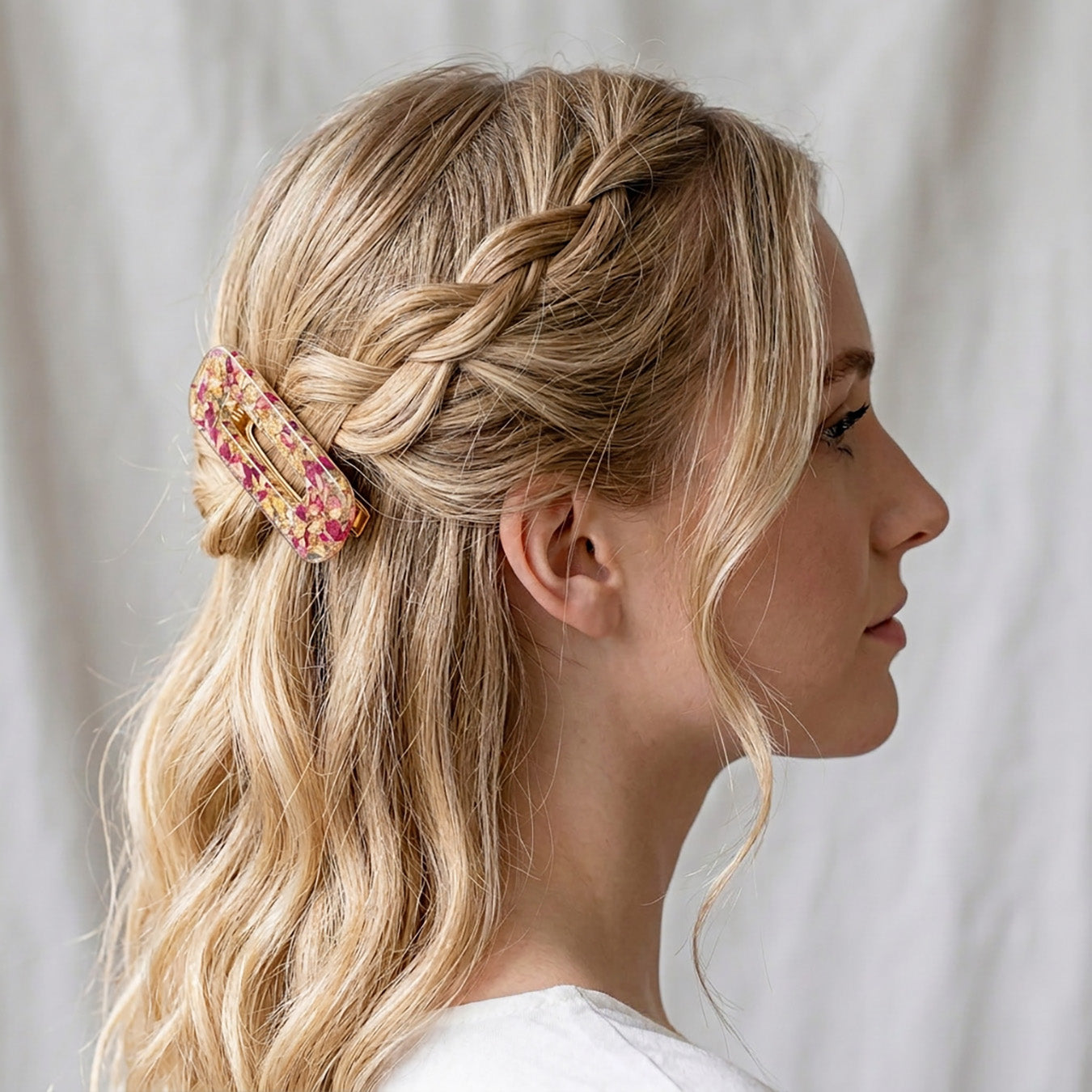 Romantic rose petal hair clip in blonde braided hairstyle side view