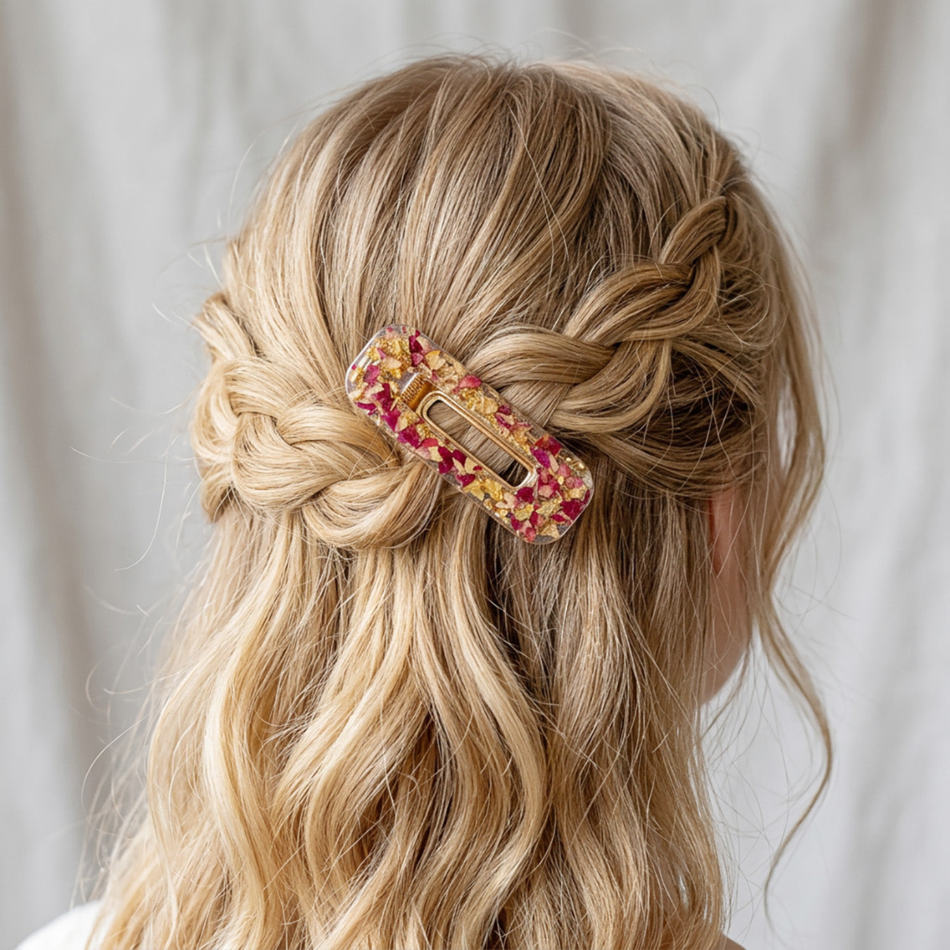 Handmade rose petal hair clip in braided blonde hairstyle