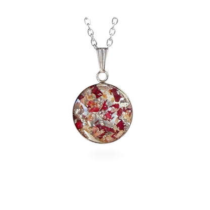 Handmade resin necklace with real rose petal fragments and silver leaf flakes, round pendant on a stainless steel chain, handcrafted in Finland.