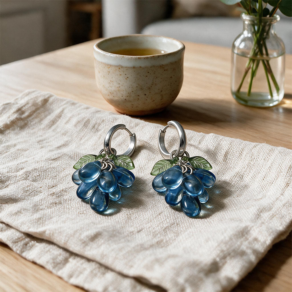 Blueberry Cluster Earrings Resting on a Linen Cloth