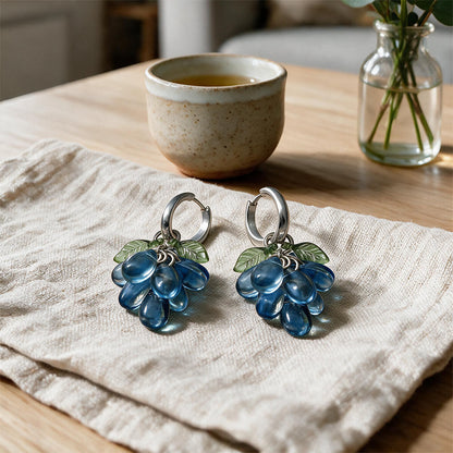 Blueberry Cluster Earrings Resting on a Linen Cloth