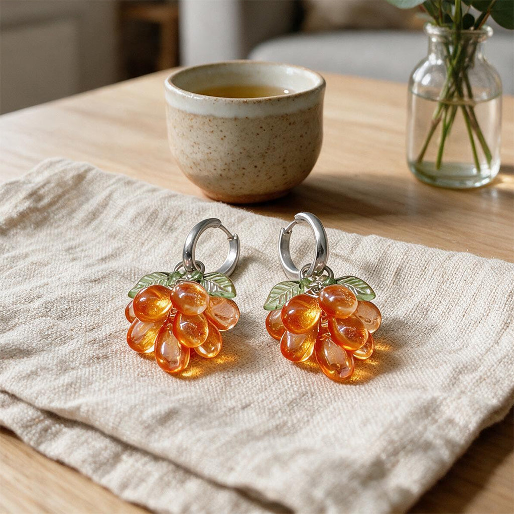 Mandarin Cluster Earrings Resting on a Linen Cloth